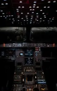 Dimly lit airplane cockpit showcasing a detailed instrument panel during night operations.